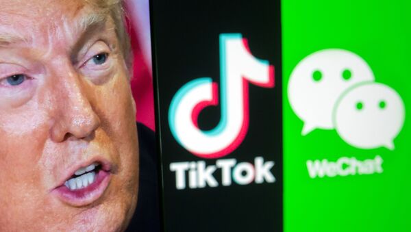 A picture of U.S. President Donald Trump is seen on a smartphone in front of displayed Tik Tok and WeChat logos in this illustration taken September 18, 2020. REUTERS/Dado Ruvic/Illustration - Sputnik Türkiye