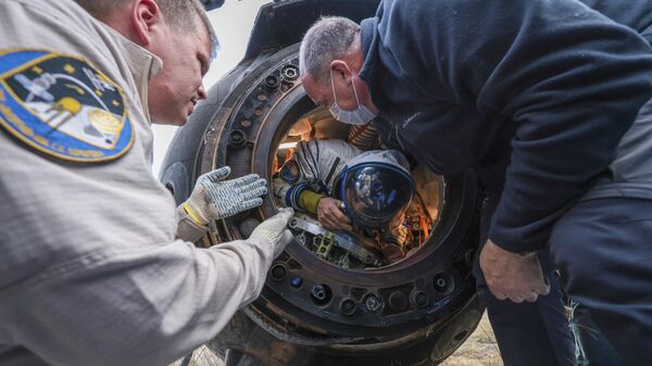 Члены спасательной команды помогают астронавту НАСА Фрэнку Рубио покинуть капсулу вскоре после приземления российского космического корабля Союз МС-23 - Sputnik Türkiye
